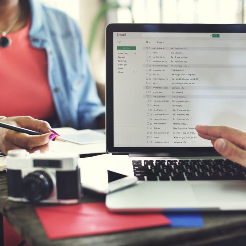 Two people working on email list management using marketing automation software